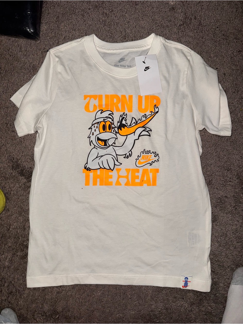 Nike White Kids 'Turn Up The Heat' Graphic Tee with Orange & Black Print